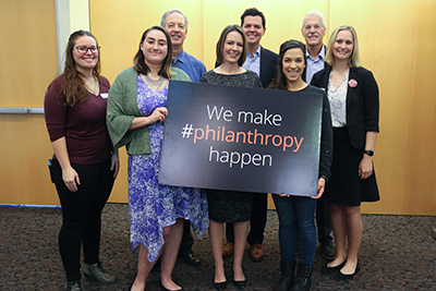 Panelists posing with Make Philanthropy Happen sign