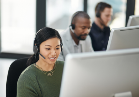 Women working on laptop while providing customer service over headset