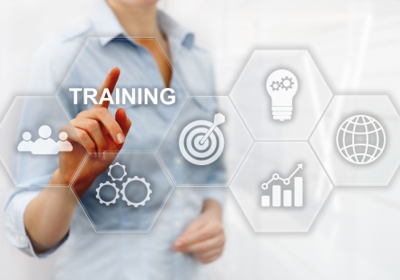 Business professional interacting with a digital interface labeled “Training,” surrounded by icons representing strategy, innovation, growth, and global impact.