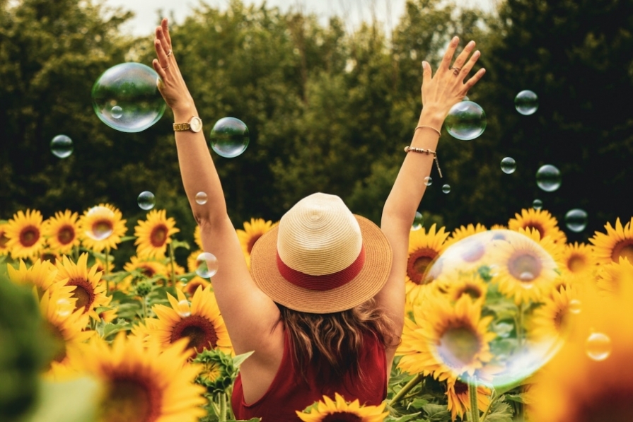 Happy woman in field of sunflowers