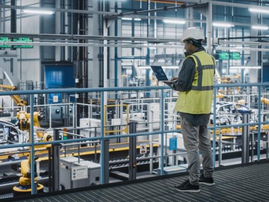 Manufacturing employee overlooking manufacturing floor