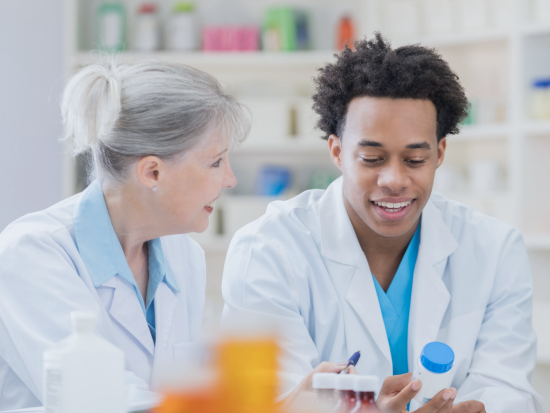 Pharmacy Technicians reviewing prescriptions in a bottle