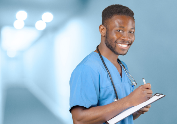 Male medical administrative assistant in blue scrubs holding clipboard and smiling