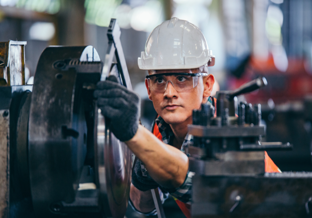 Man in hard hat working on machine