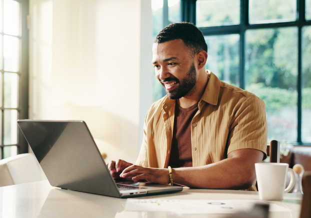 Male working on laptop by himself